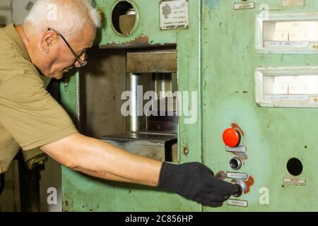 man working on machine in a factory
