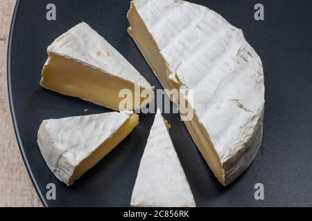 Camembert cheese is a soft elite French cheese with a crust of white mold. Made from cow's milk. Stock Photo