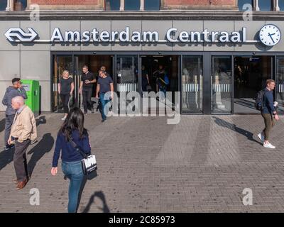 Amsterdam, Netherlands - October 15 2018: Commuters and tourists make their way in and out of Centraal Station in Amsterdam.