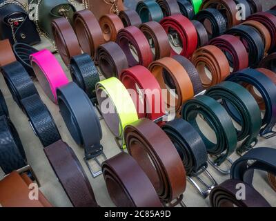 A section of unbranded leather belts for sale at Spitalfields market in London Stock Photo