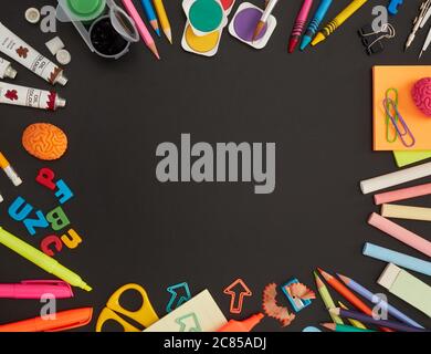 School supplies on blackboard Stock Photo