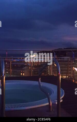Whirlpool on a roof top with view on Calella, Spain at night. Stock Photo