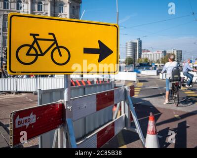 Amsterdam, Netherlands - October 15 2018: Yellow street signs directs cyclists which way to travel through the city centre Stock Photo