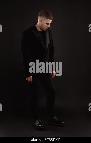Handsome man in formal suit isolated on black background Stock Photo