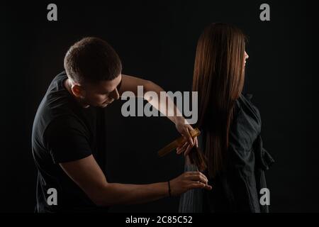 Student Hairdresser Cutting Hair. Hairdresser styling womans hair Stock Photo