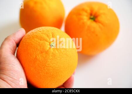 three large oranges lie on a white background Stock Photo
