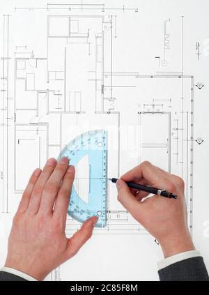 Architect drawing on blueprints Stock Photo