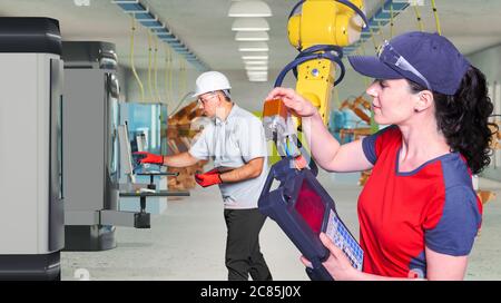 The technicians while machine constructing or mechanical engineering in a manufacturing plant Stock Photo