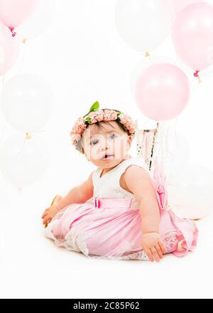 Vertical lifestyle portrait of a baby girl on her first birthday. Stock Photo