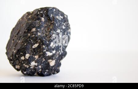 Concept image. Volcanic rock isolated on beautiful white background. Web banner with a copy space. Stock Photo
