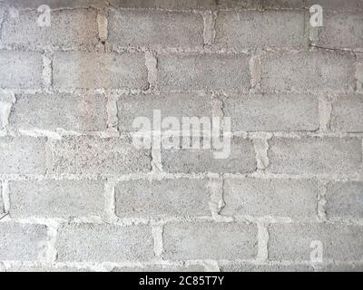 Closeup shot of the wall made up of gray rectangular stones and concrete Stock Photo