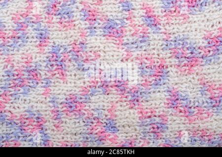 Knitted textured background in delicate white, pink and lilac colors. Winter christmas background Stock Photo