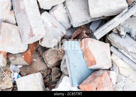Closeup photo of a pile of broken brick on the ground. Stock Photo