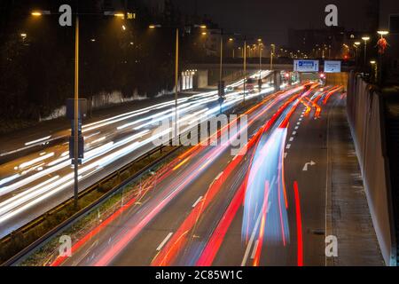 Fast moving traffic passes along a German highway which leads from Munich city centre towards the airport during the evening rush hour. Stock Photo