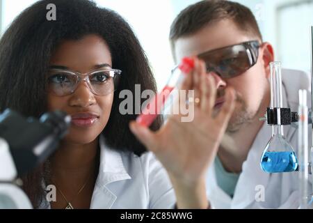 Two scientists doing chemical experiment in laboratory Stock Photo
