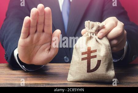 Businessman refuses to give turkish lira money bag. Asset freeze. Stop financing projects and reforms, crisis financial difficulties. Loan refusal, ba Stock Photo