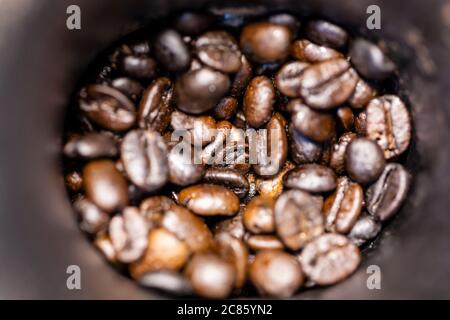 Roasted coffee beans inside in the manual grinder. Stock Photo