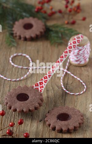 christmas chocolate biscuits spitzbuben on wooden table Stock Photo