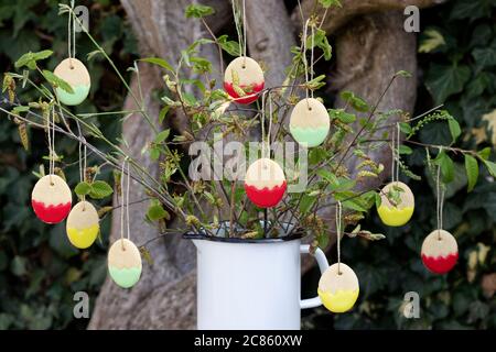 easter bakery biscuits in form of easter eggs hangign on branches Stock Photo