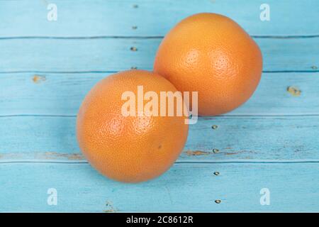 Grapefruits on a rustic blue wooden table Stock Photo