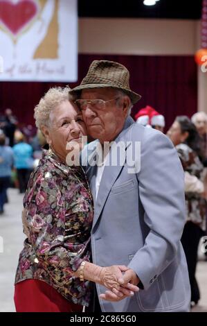 San Antonio, Texas USA, November 24, 2005: People dancing at the 26th annual Raul Jiminez Thanksgiving Dinner where over 25,000 meals are served on Thanksgiving Day for the elderly, homeless, poor and displaced of south Texas. ©Bob Daemmrich Stock Photo