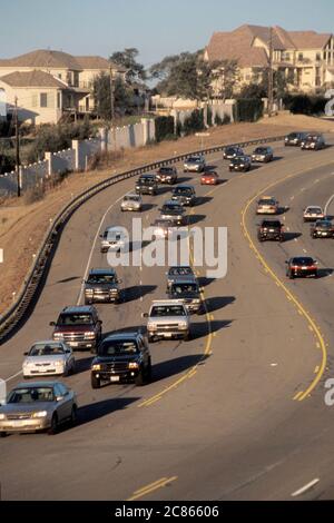 Austin, Texas USA, June 2004: Heavy traffic goes one direction while road is clear going the other direction during rush hour on highway near residential area.  ©Bob Daemmrich Stock Photo