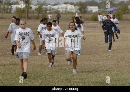 Pflugerville Texas USA, 2005: 7th and 8th grade students run on athletic field during gym class at their middle school. ©Bob Daemmrich Stock Photo