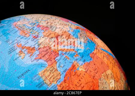 Illuminated globe with Europe and North Africa visible against black background. Stock Photo