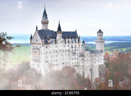 Neuschwanstein Castle or Schloss Neuschwanstein in foggy autumn day in southwest Bavaria, Germany Stock Photo