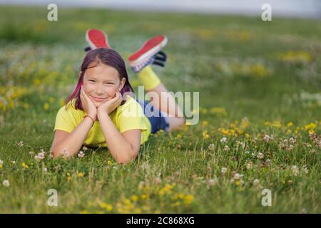 Premium Photo | Handsome young man laying down on grass during summer at  park