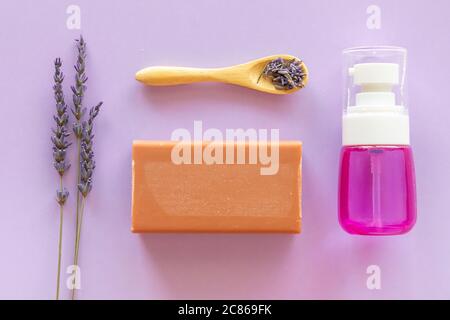Lavender Soap, lavander hydrolyte and bouquet on violet background, Homemade cosmetics, Beauty Concept Stock Photo