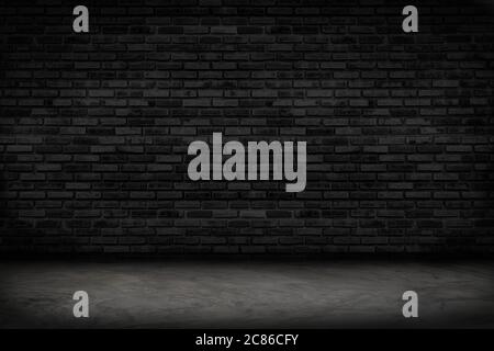 Empty black brick wall and concrete floor for background. Dark room interior with black brick wall blank cement floor for backdrop. Stock Photo