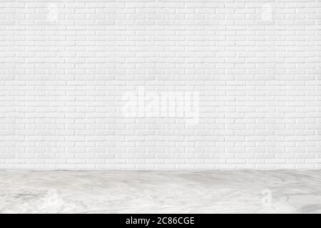 Empty white brick wall and concrete floor for background. room interior with white brick wall blank cement floor for backdrop. Stock Photo