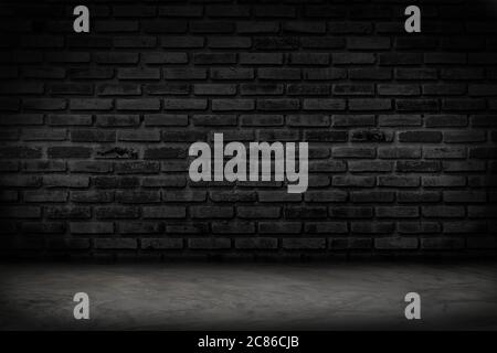 Empty black brick wall and concrete floor for background. Dark room interior with black brick wall blank cement floor for backdrop. Stock Photo