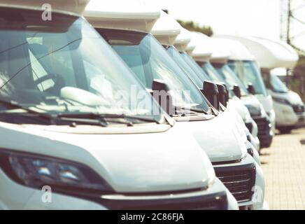 Line of Brand New Camper Vans Motorhomes Awaiting Clients on Dealership Sales Lot. Recreational Vehicles Selling. Caravaning Industry. Stock Photo