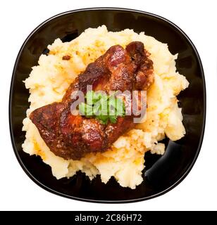 Roasted pork neck with potatoes decorated with coriander leaf isolated on white background Stock Photo