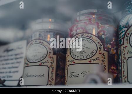 Stow-on-the-Wold, UK - July 6, 2020: Retro sweets in jars on display in shop window in Cotswolds, an area in south central and south west England Desi Stock Photo
