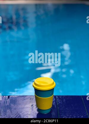 reusable bamboo mug at the swimming pool Stock Photo