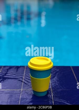 reusable bamboo mug at the swimming pool Stock Photo