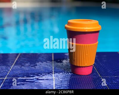 reusable bamboo mug at the swimming pool Stock Photo