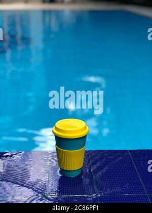 reusable bamboo mug at the swimming pool Stock Photo