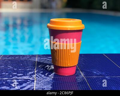 reusable bamboo mug at the swimming pool Stock Photo