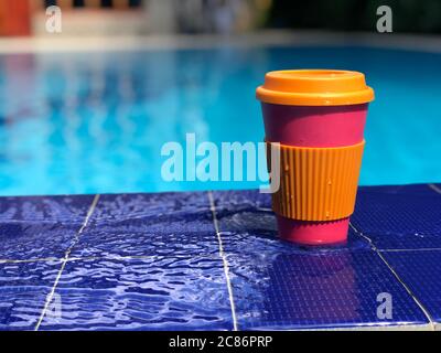 reusable bamboo mug at the swimming pool Stock Photo