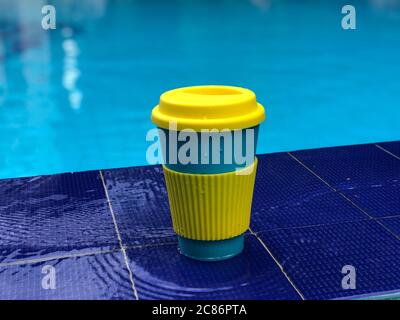 reusable bamboo mug at the swimming pool Stock Photo