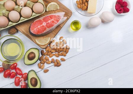 Keto diet, low carb healthy food. avocado, fish, oil, nuts on white background Stock Photo