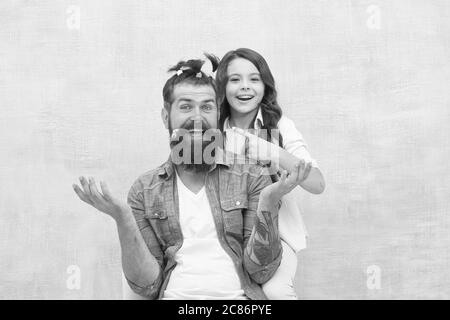 Having fun. happy family day. small girl play with dad. bearded man father having fun with kid. childrens day. love and trust. daughter and father with funny hairdo. hairdresser and barbershop. Stock Photo