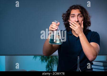 Young student in the classroom at night Stock Photo