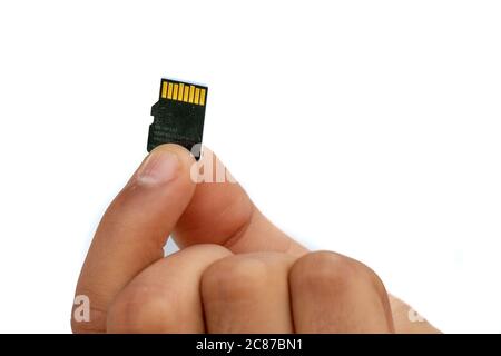 Micro SD Card holds in hand finger isolated on white background Stock Photo