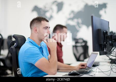 startup business, two male software developers working on computer at new modern open plan office Stock Photo