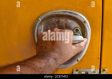 Open The Door Of A Yellow Truck On Hand. Stock Photo